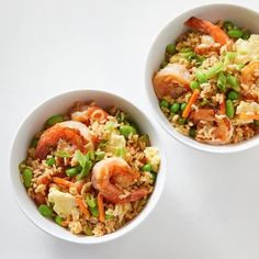 two bowls filled with rice and vegetables on top of a white countertop next to each other