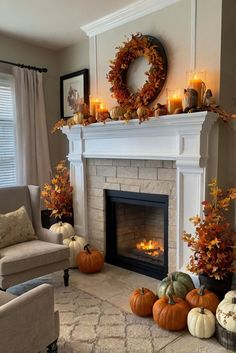 a living room decorated for fall with pumpkins, candles and wreath on the mantle