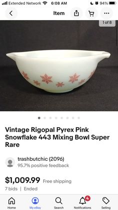 a white bowl with red flowers on it is for sale in the store, and has been