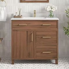 a bathroom with a sink, mirror and wooden cabinet