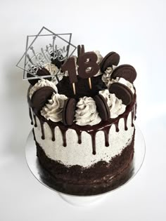 a chocolate cake with white frosting and oreo cookies on top