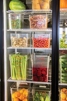 a refrigerator filled with lots of different types of fruits and veggies in bins