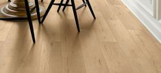 three stools sitting on top of a hard wood floor next to a kitchen counter