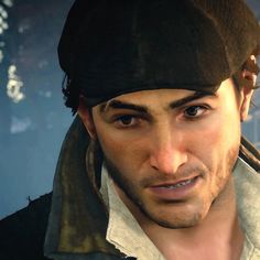 a close up of a person wearing a hat and looking at the camera with an evil look on his face