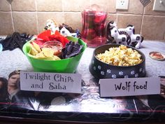 two bowls filled with food sitting on top of a table next to pictures and decorations