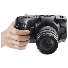 a person holding a camera in their right hand and pointing it at the camera with both hands