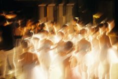 blurry photograph of people dressed in white