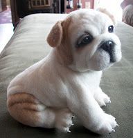 a small white dog sitting on top of a bed