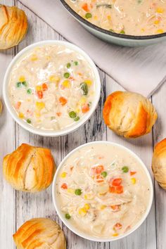 two bowls of chicken pot pie soup next to croissants