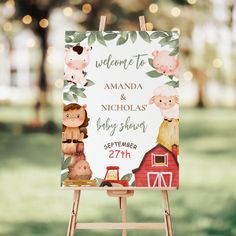 an easel with a sign on it that says welcome to amanda and nicholas baby shower