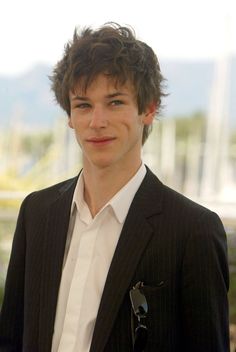 a young man wearing a suit and tie