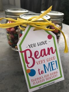 a jar filled with lots of candy sitting on top of a table next to a sign that says you have bean very good to me