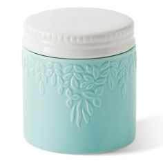 a light blue jar with white lid on a white background, decorated with flowers and leaves