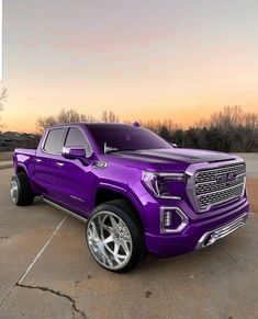 a purple truck parked in a parking lot