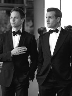 two men in tuxedos standing next to each other