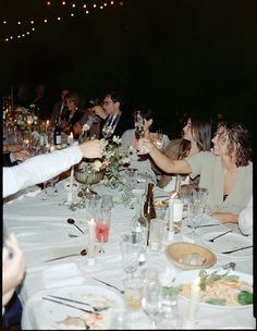 a group of people sitting around a dinner table