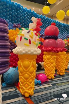 there are many ice cream cones on display