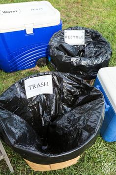 trash bags and coolers sitting in the grass with labels on them that say trash