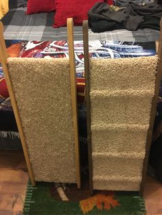 a bed with two tall wooden posts sticking out of it's sides and carpet on the floor