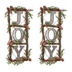 two metal letters decorated with pine cones and holly