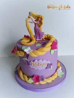 there is a purple cake with a princess on it