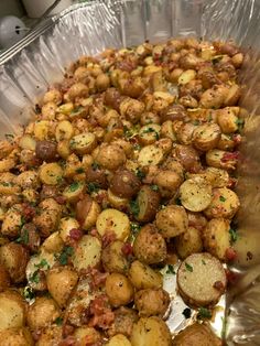 a pan filled with cooked potatoes covered in seasoning