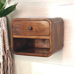 a wooden shelf with a potted plant next to it