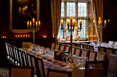 a long table is set with glasses and candles