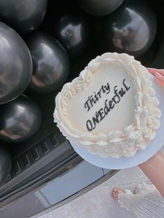 there is a birthday cake with the words thirty onederful on it and balloons in the background