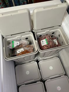 three coolers filled with food sitting on top of a refrigerator freezer door next to each other