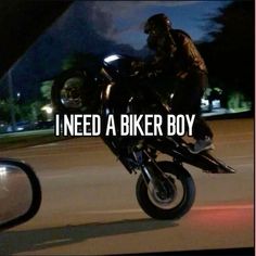 a man riding on the back of a black motorcycle at night with words above it