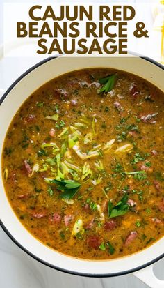 a bowl of cajun red beans, rice and sausage soup on a white table