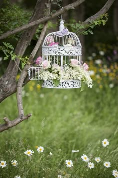 a white birdcage with flowers hanging from it's side and the words today, be encouraged