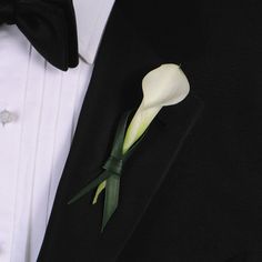 a man in a tuxedo with a boutonniere on his lapel