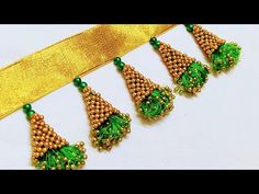 green and gold beaded necklaces on a yellow ribbon