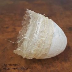 a piece of white fabric sitting on top of a wooden table