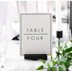 a table sign sitting on top of a white table