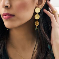 The Leya earrings are the most exquisite chandelier earrings you'll own! Finished with a jade gemstone, these earrings will give you the elevated look without the weight on your ears.   Style Tip: Pull out your all black look and accentuate your fit with these eye catchers. Material: Brass Metal, 21 Karat Gold Plated with Lacquer Coating.  Stone: Emerald Push back earrings.  Our jewelry is handmade. Please note while pieces may be adjustable they are delicate in nature and must be adjusted gently. Elegant Green Hammered Earrings, Dangle Earrings With May Birthstone In Metal, May Birthstone Dangle Earrings, Black Look, Jade Gemstone, All Black Looks, Brand Magazine, Ethical Brands, Artisan Gift