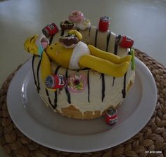 a cake decorated to look like a woman laying on top of a banana split with chocolate drizzles