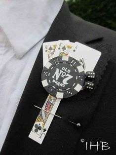 a man wearing a black suit and white shirt has a badge on his lapel