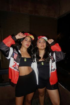 two women dressed in costumes posing for the camera