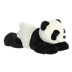 a black and white stuffed panda laying down