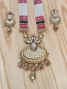 Elegant and sophisticated-looking Rajwadi Pendant Necklace with Kundan Stones Highlights of the necklace ** Rajwadi Finish Pendant, with Kundan Stones  ** Length of the necklace: 24 Inches with Dori in the back ** Length of the pendant 4 Inches (Please check the picture for the measurement) ** Dangle and Drop Lightweight Earrings. ** Length of the earrings: 2 Inches ** Long Pearl Mala Necklace ** Very Versatile, suitable for any occasion. ** Adjustable chain in the back ** Free shipping Pair this beauty with a Lehenga saree for any event. This will surely make your outfit look more sophisticated. I captured as many details as possible in my pictures and descriptions. If you have any other questions, feel free to contact us. Check out our other listings at: https://www.etsy.com/shop/mdbeadw Pink Temple Necklace For Diwali Celebration, Pink Temple Jewelry Necklace For Diwali, Pink Temple Jewelry Chandbali Necklace, Pink Jewelry For Puja Festivals, Pink Hand Set Temple Jewelry Necklace, Festive Pink Jewelry For Puja, Pink Necklace With Intricate Design For Festive Occasions, Traditional Pink Kundan Necklace With Latkans, Pink Necklaces With Intricate Design For Festive Occasions