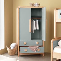 a child's bedroom with a blue armoire next to a bed