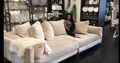 a woman sitting on a couch in a store