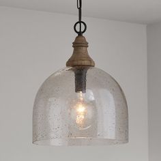 The mixed-material look of this 1-light single pendant is the perfect blend of coastal and farmhouse styles in your space. It's made from a blend of metal and wood with dark pewter and brown finish for two-toned color contrast. The rounded canopy easily mounts to ceilings - even sloped ceilings! - and the chain is adjustable to suit the size of your kitchen, entryway, or dining room. Its 15" wide dome-shaped shade comes in your choice of glass, and it disperses light from a single bulb up to 100 Dark Pewter, Kitchen Entryway, Pewter Pendant, Pendant Ceiling Light, Hudson Valley Lighting