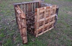 a pile of wood sitting on top of a lush green field