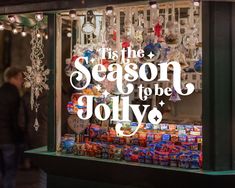 a store front window with christmas decorations on display