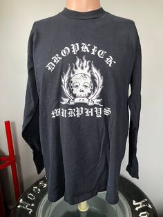 "True vintage Dropkick Murphys Fire & Brimstone longsleeve t-shirt from 1998. Size large single stitched tee in good shape, couple of tiny holes on the front. Measures 21.5\" pit to pit, 25.5\" collar to bottom." 90s Graphic Print Long Sleeve T-shirt, Y2k Long Sleeve T-shirt For Streetwear, Grunge Long Sleeve T-shirt With Graphic Print, Black Long Sleeve T-shirt 90s Style, 90s Long Sleeve Graphic T-shirt, Long Sleeve Y2k T-shirt With Screen Print, Y2k Long Sleeve T-shirt With Screen Print, Y2k Long Sleeve Screen Print T-shirt, Vintage Long-sleeve Graphic Print T-shirt