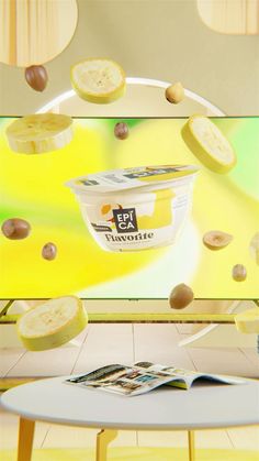 an ice cream container is falling into the air with nuts coming out of it on a table in front of a television screen